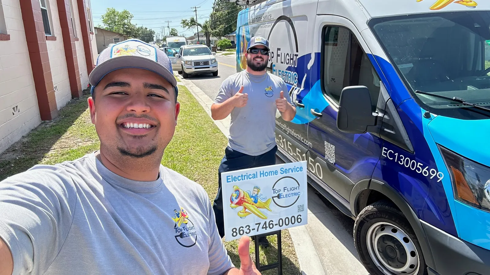 Top Flight Electric technicians on a job with the company van and yard sign