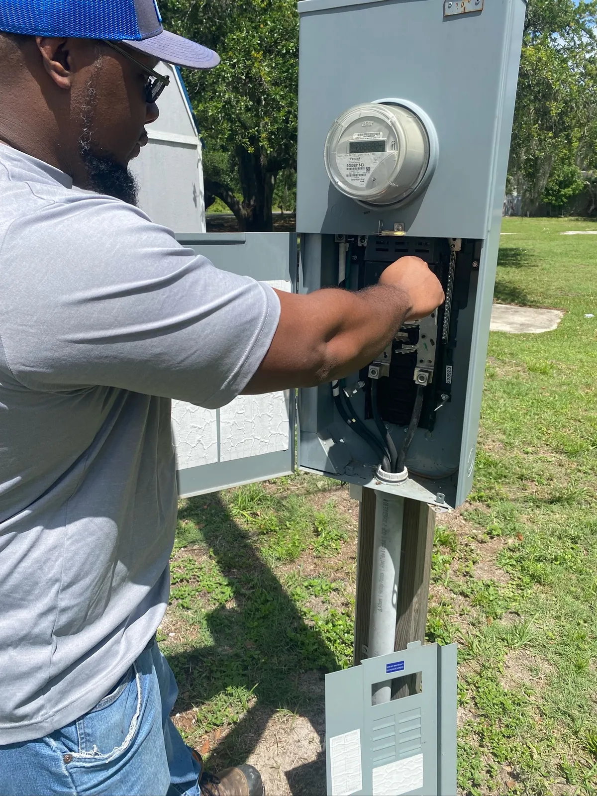 Electrician servicing an older home's meter and service equipment