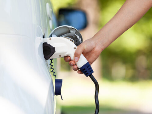 Electric,Car,Battery,Charging,At,Charge,Station,In,The,Nature