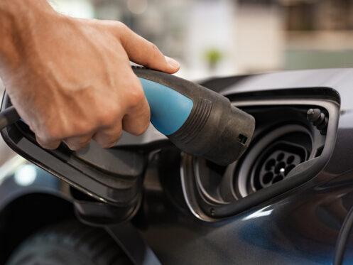 Closeup,Of,Man,Hand,Installing,Power,Cable,Supply,For,Charging